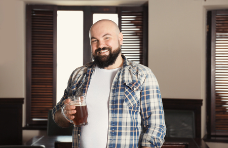 Man with glass of beer in pubの写真素材