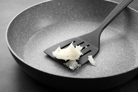 Spatula with coconut oil on frying panの写真素材