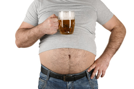 Man with big belly holding glass of beer on white backgroundの写真素材