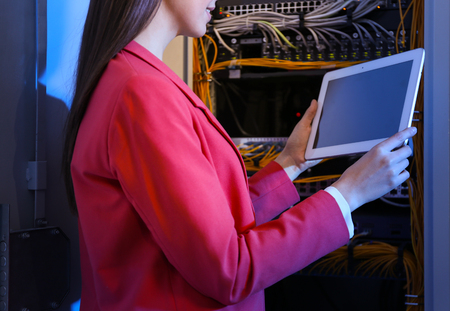 Beautiful young engineer with tablet computer in server roomの写真素材