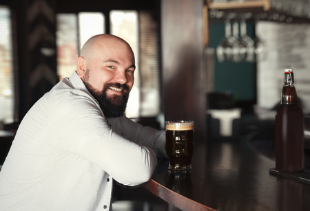 Man with glass of beer in pubの写真素材
