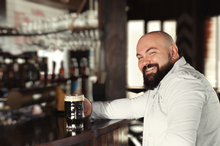 Man with glass of beer in pubの写真素材
