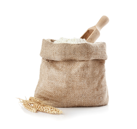 Bag with flour and wooden scoop on white backgroundの写真素材