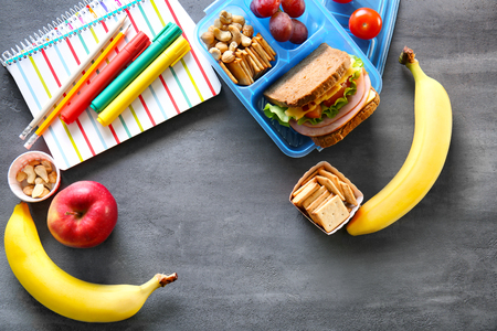 School lunch and stationery on tableの写真素材