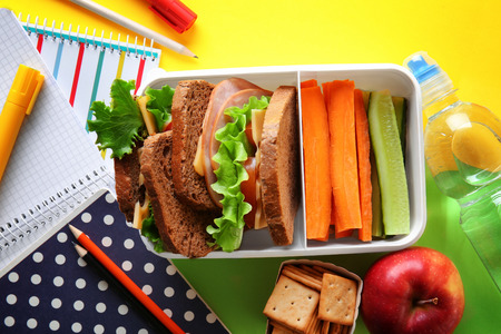 School lunch and stationery on tableの写真素材