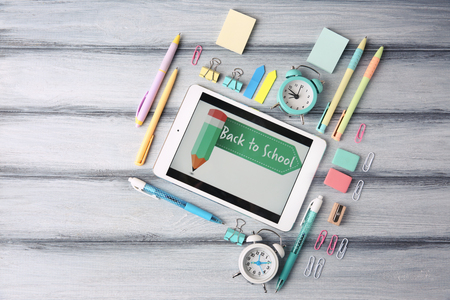 Tablet and stationery on table, top viewの写真素材