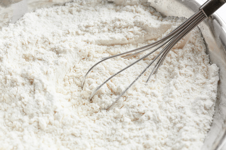 Bowl with flour and whisk, closeupの写真素材