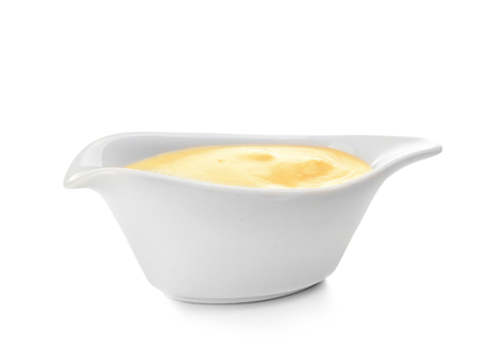 Sauceboat full of creamy cheese, isolated on white backgroundの写真素材