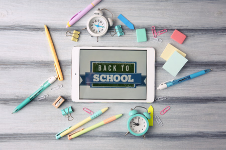 Tablet and stationery on table, top viewの写真素材