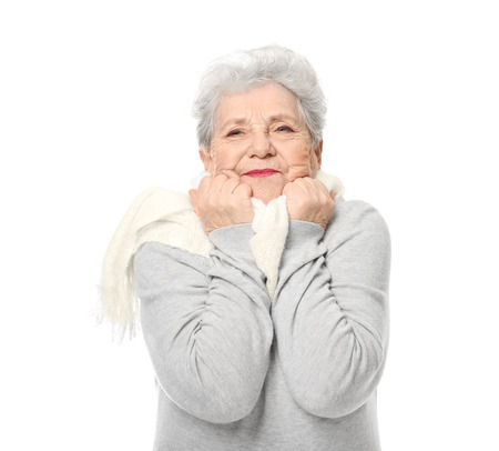 Portrait of elderly woman feeling cold on white backgroundの写真素材