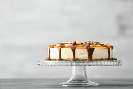 Tasty cheesecake with fruits and chocolate on standの写真素材