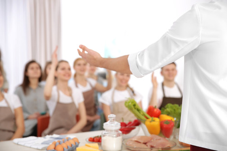 Male chef and group of people at cooking classesの写真素材