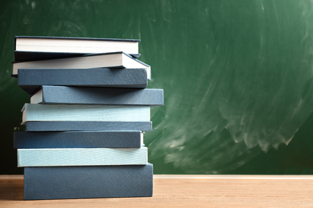 Books on chalkboard backgroundの写真素材