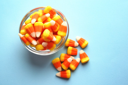 Colorful Halloween candy corns on blue backgroundの写真素材