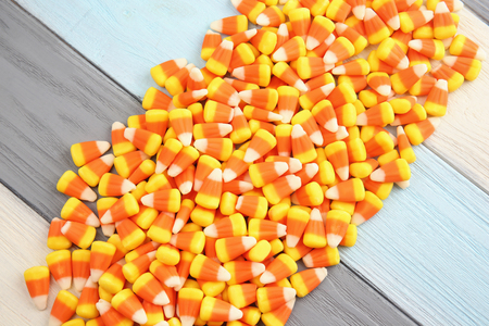 Colorful Halloween candy corns on wooden backgroundの写真素材