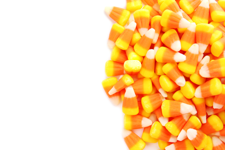 Colorful Halloween candy corns on white background