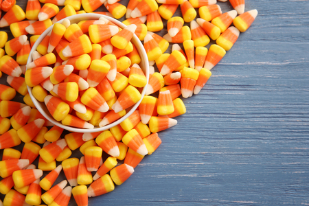 Colorful Halloween candy corns on wooden backgroundの写真素材