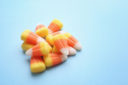 Colorful Halloween candy corns on blue backgroundの写真素材