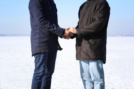 Happy gay couple holding hands together, outdoorsの写真素材