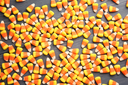 Colorful Halloween candy corns on wooden backgroundの写真素材