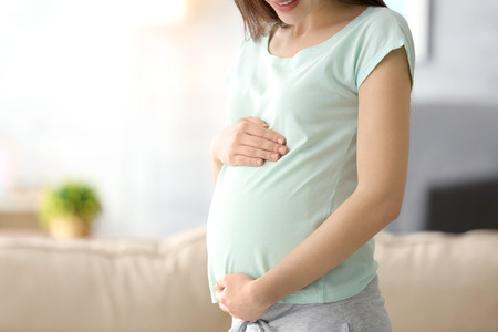 Beautiful pregnant woman at home