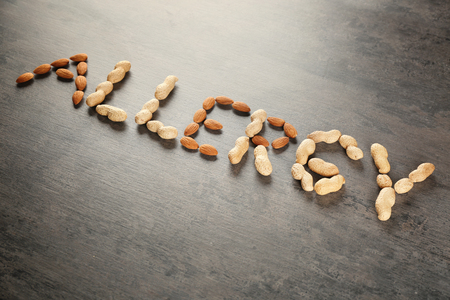 Word ALLERGY made of nuts on color backgroundの写真素材