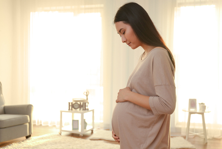 Pregnant Asian woman at homeの写真素材
