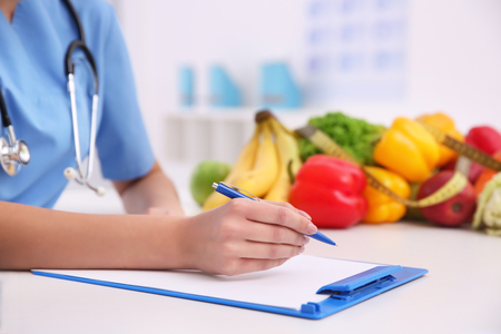 Young female nutritionist working in her office, closeupの写真素材
