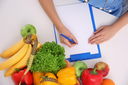 Hands of female nutritionist counting calories in hospitalの写真素材
