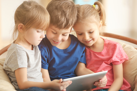 Cute kids using digital tabletの写真素材