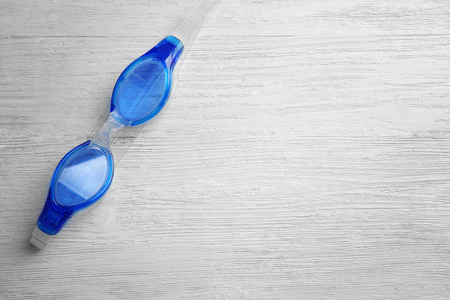Swimming goggles on wooden backgroundの写真素材