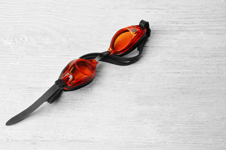Swimming goggles on wooden backgroundの写真素材