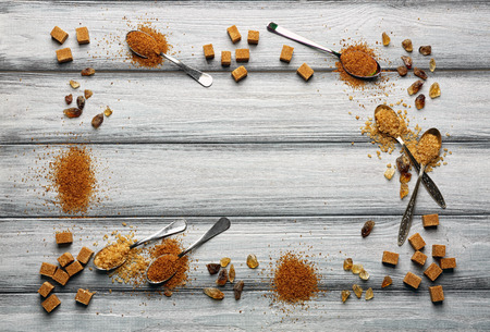 Composition with brown sugar on light wooden backgroundの写真素材