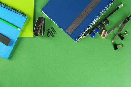 Colorful school stationery on color background, top view