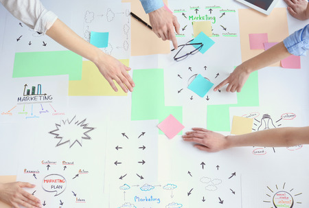 Group of people working on marketing plan in office
