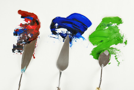 Palette knives with paint on paperの写真素材
