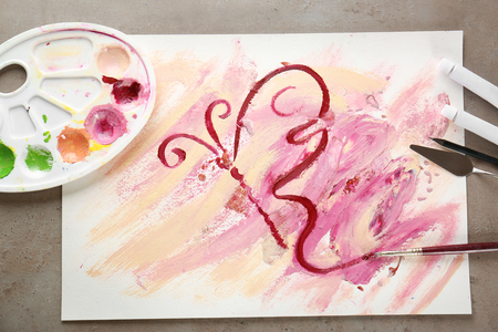 Beautiful painting of butterfly with artist's tools on tableの写真素材
