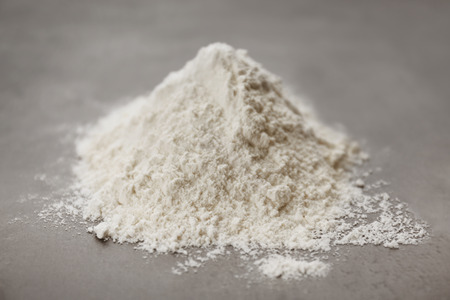 Heap of flour on grey backgroundの写真素材
