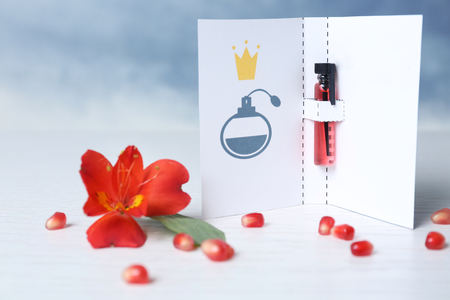 Beautiful composition with perfume sample in paper cover on blurred backgroundの写真素材
