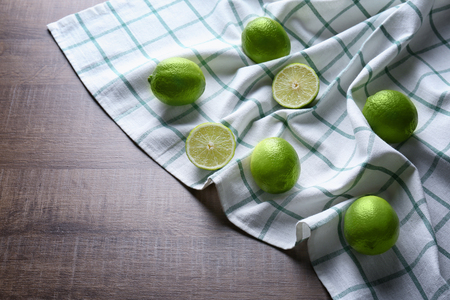 Simple composition with juicy limes on tableの写真素材