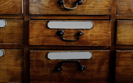 Vintage wooden drawer with inscriptions in old pharmacy, closeupの写真素材