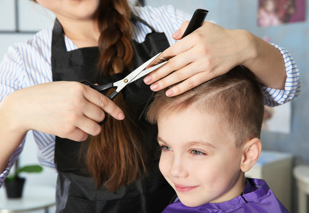 Cute little boy in hairdressing salonの写真素材