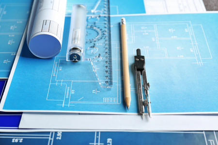 Different kinds of engineering tools on construction drawings backgroundの写真素材