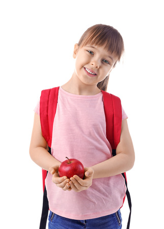 Happy schoolgirl with backpack and apple on white backgroundの写真素材