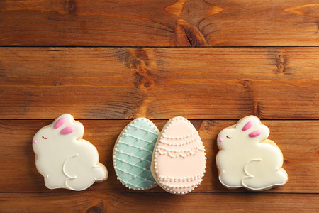 Creative Easter sugar cookies on brown wooden backgroundの写真素材