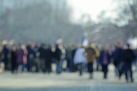 Crowd of people walking on busy city street, blurred viewの写真素材