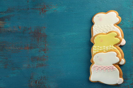 Creative rabbit shape Easter cookies on wooden background
