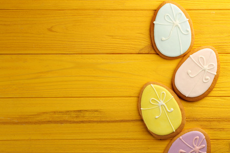 Creative Easter sugar cookies on yellow wooden background