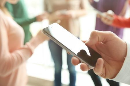 Male hand with smartphone, closeupの写真素材