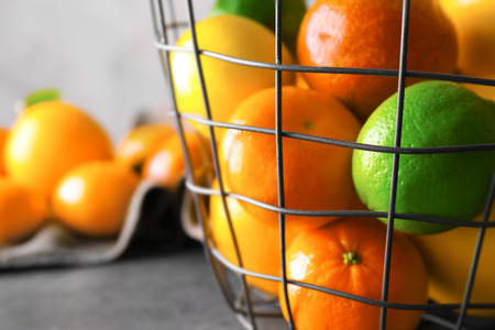 Metal basket with fresh citrus fruits, closeupの写真素材